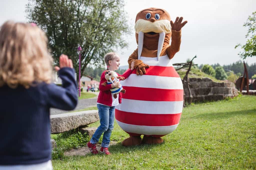 Walross Trixi das Maskottchen im Ferienpark mit Kindern am Spielplatz